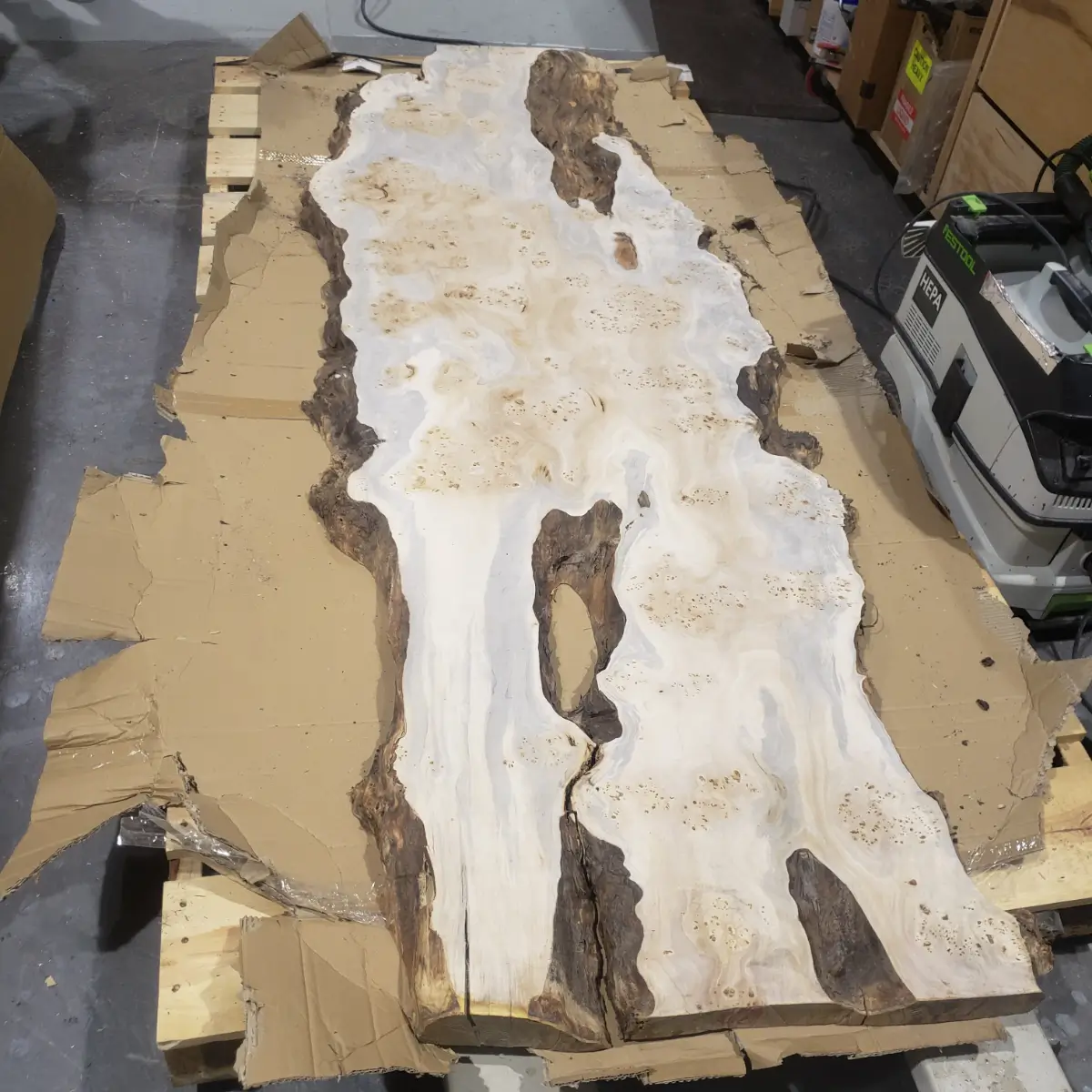 Live-edge burl wood slab on pallet